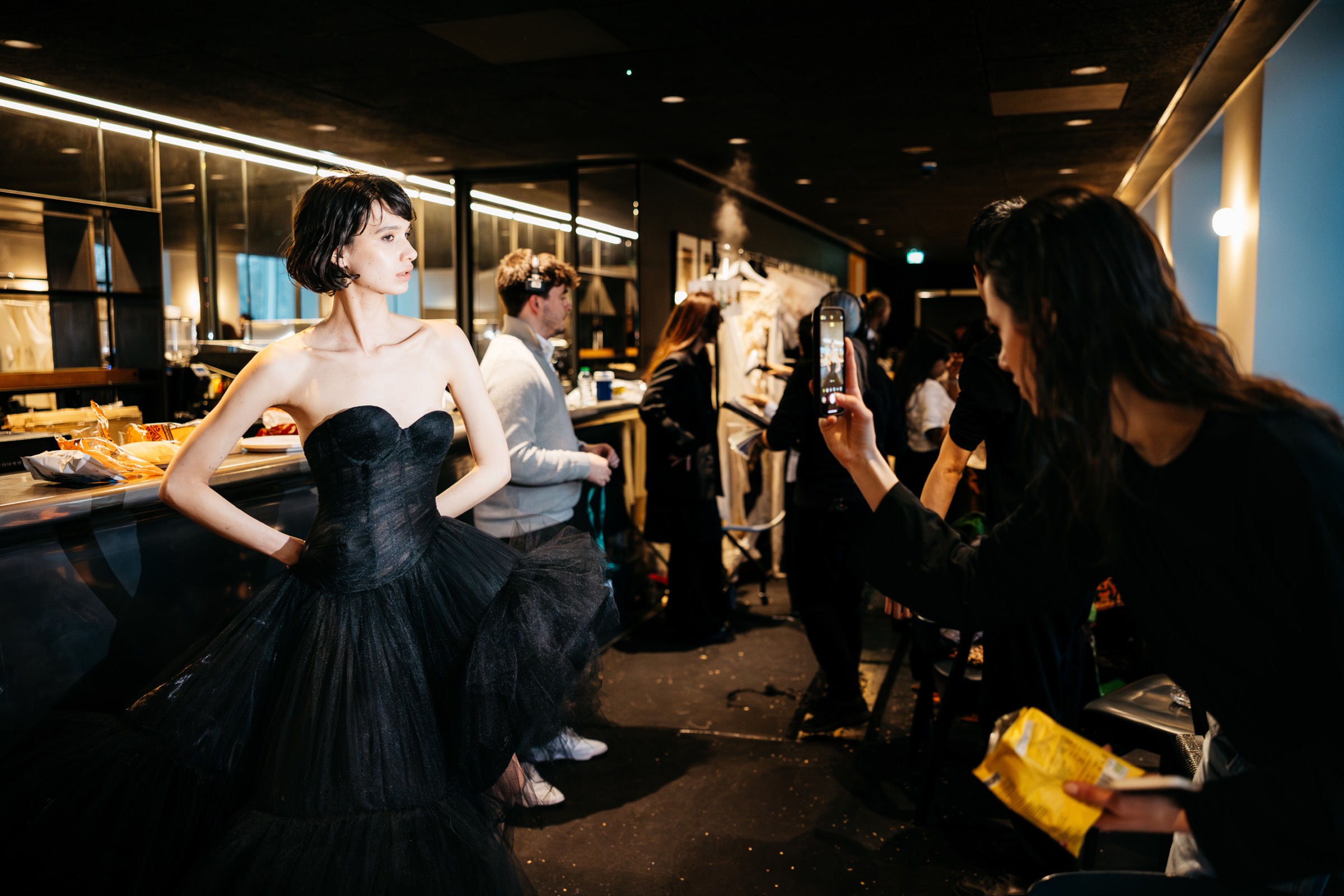 A model backstage in a black gown at a Fashion 4.0 London Fashion Week showcase